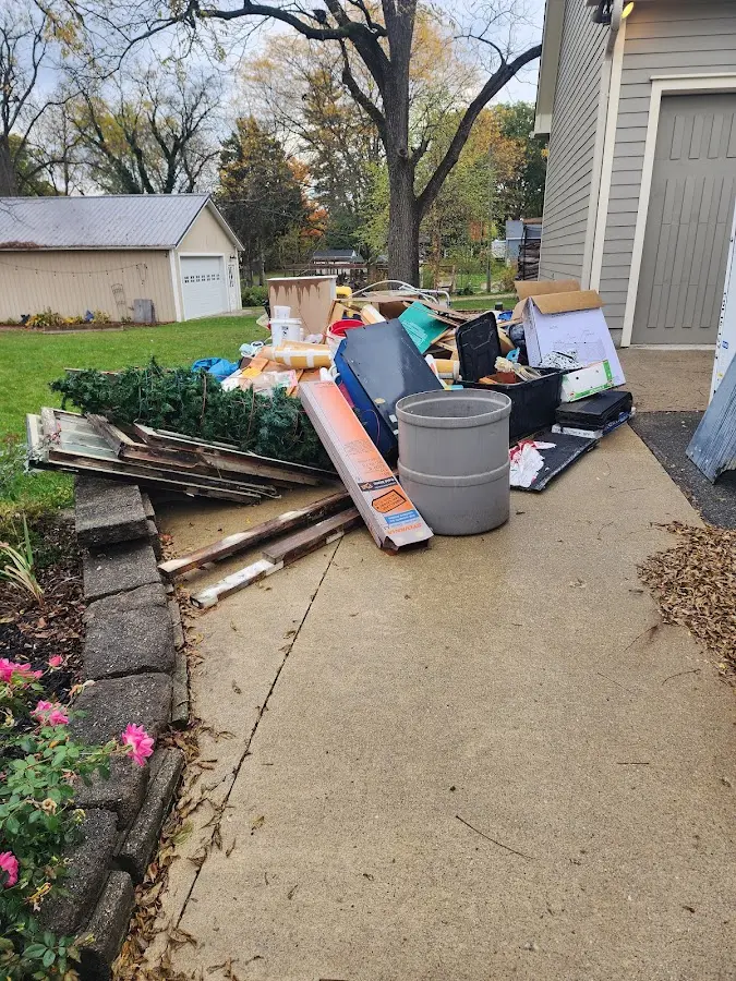 Dumpster being loaded with debris for Estate Cleanout Dumpster Rental in Mahomet
